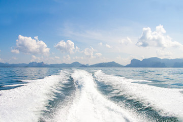 Boat wake prop wash on blue ocean sea in sunny day