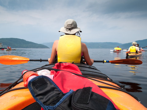 Tourists Kayaking In River, Quebec, Canada