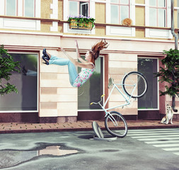 girl falling off her bicycle