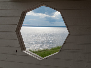 River viewed through a hole in wall, Quebec, Canada