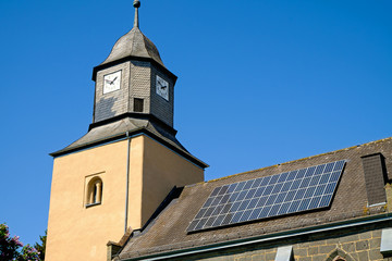An old church with solar panels on the roof