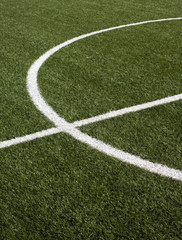 Part of a soccer field with green synthetic grass closeup