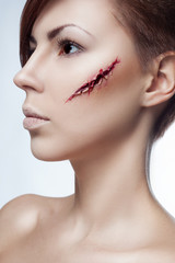 beautiful girl with a cut on face