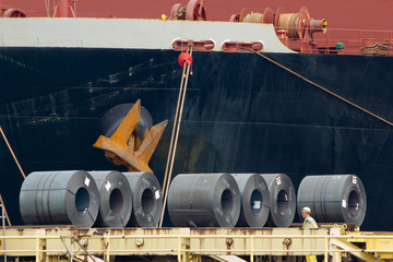 Coiled steel sheets being loaded in a ship