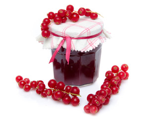 Jar of redcurrant jam with fresh redcurrants