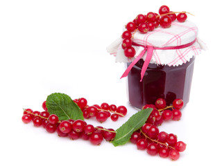 Jar of redcurrant jam with fresh redcurrants and mint