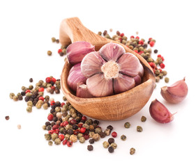 Garlic cloves in wooden bowl isolated on white background