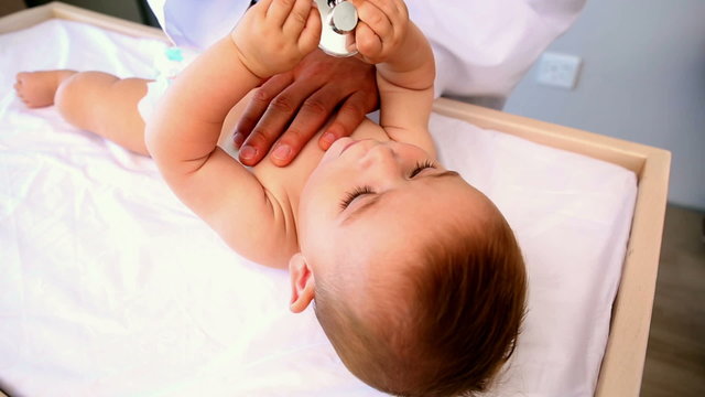 Pediatrician examining baby boy