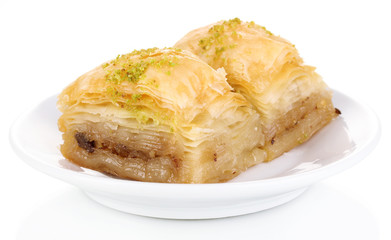 Sweet baklava on plate isolated on white