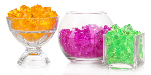 A glasses with colorful decorative stones isolated on white