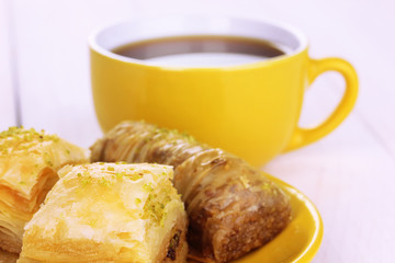 Sweet baklava on plate with tea close-up