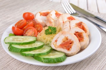 Delicious chicken roll on plate on table close-up
