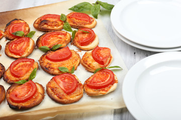 Small pizzas on baking paper close up