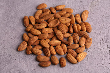 Almonds on color wooden background