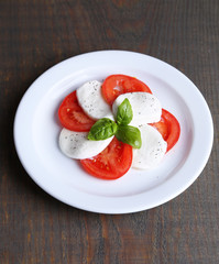 Caprese salad with mozarella cheese, tomatoes and basil