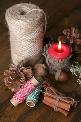 Fototapeta na wymiar Composition with natural bump, candle, thread, cinnamon sticks