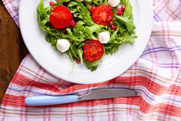 Green salad made with  arugula, tomatoes, cheese mozzarella
