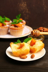 Tasty pumpkin muffins on wooden table