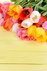 Beautiful tulips in bucket on table close-up