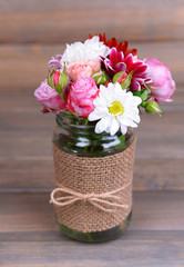 Beautiful bouquet of bright flowers in jar