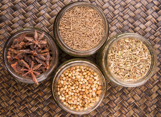 Spices and herb varieties over a wicker background 