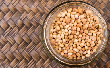 Coriander seed over a wicker background 