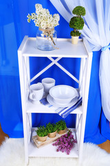 Beautiful white shelves with tableware and decor