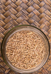 Cumin seeds over a wicker background 