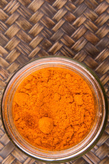 Curry powder spices over wicker background