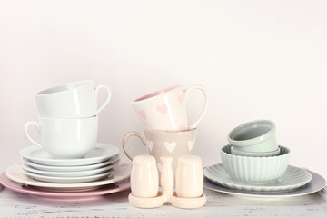 Different tableware on shelf, isolated on white