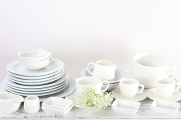 Different tableware on shelf, isolated on white