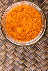Curry powder spices over wicker background