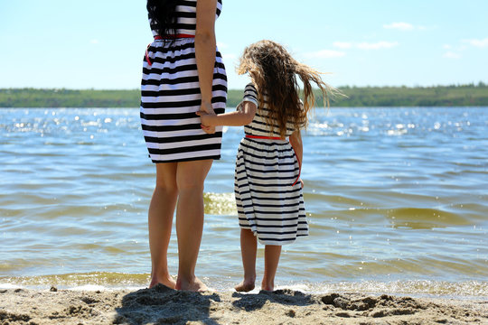 Happy Mom And Daughter On The Beach