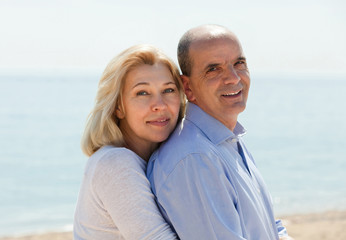 Mature couple against sea in background