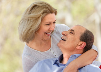 Happy aged man and woman hugging each other
