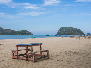 Wooden bench in front of the sea