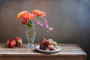 Flowers and fruits on wooden vintage table © maglara