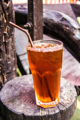 Cold iced tea with straws in the back yard