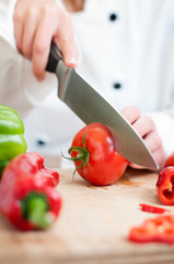chef cutting tomatoes