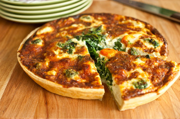 spinach quiche on a wooden plate
