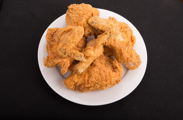 Plate of Fried Chicken on Black Background