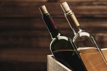 Bottle of red and white wine in wooden box