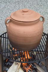 Clay pot with cabbage on fire