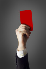 businessman showing red card