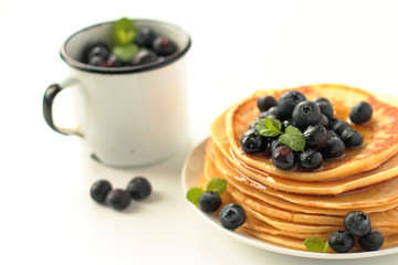 Stack of pancakes with fresh blueberries fruits and honey
