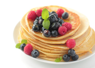 Stack of pancakes with fresh blueberry and raspberry