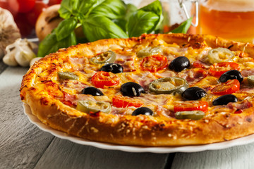 Pizza with bacon, olives and jalapeno pepper