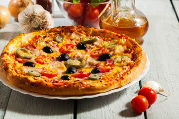 Pizza with bacon, olives and jalapeno pepper