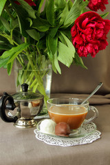 Bouquet of peonies, coffee and sweets.
