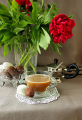 Bouquet of peonies, coffee and sweets.